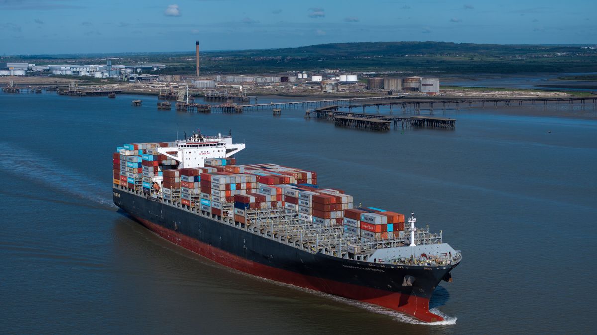 CANVEY ISLAND, ENGLAND - APRIL 20: A container ship, the Nansha Express makes its way towards Antwerp on the River Thames past the The Oikos bulk liquid fuel storage facility on April 20, 2026 in Canvey Island, England. The disruption to oil and gas shipments through the Strait of Hormuz caused by the US-Iran war has caused global market volatility and raised concerns about fuel supply in a range of countries, including the UK. (Photo by Dan Kitwood/Getty Images)