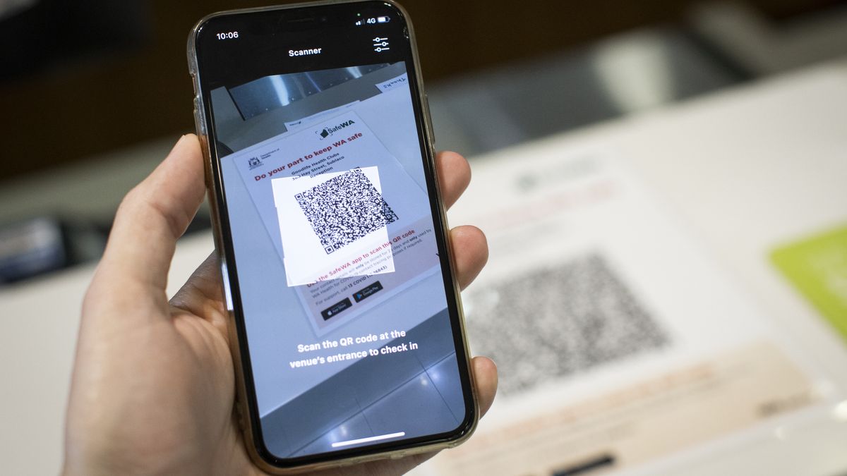 PERTH, AUSTRALIA - DECEMBER 05: A patron scans a QR code using the SafeWA app on a mobile phone at a gym on December 05, 2020 in Perth, Australia. From Saturday, people in Western Australia will need to register their details when visiting various locations as part of the WA government's introduction of compulsory contact registers and QR codes for COVID-19 contact tracing. (Photo by Matt Jelonek/Getty Images)