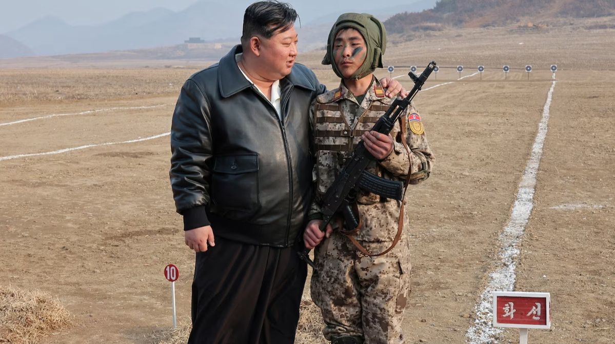 Kim Jong Un, the leader of North Korea, and one of the soldiers