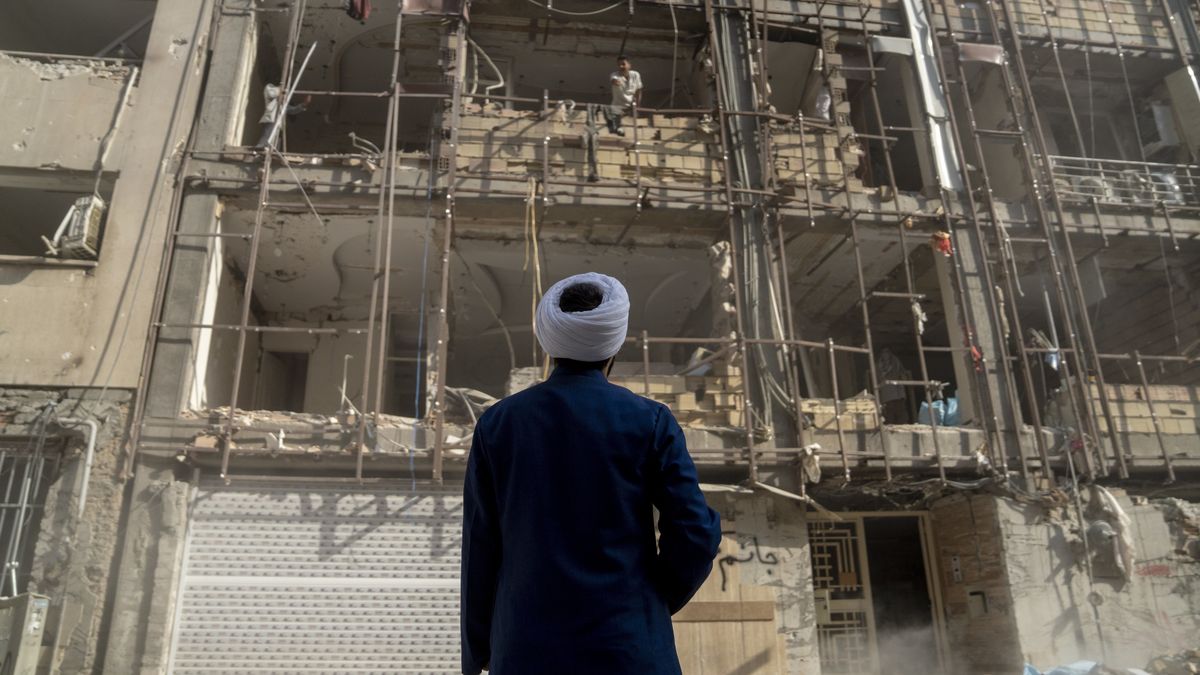 TEHRAN, IRAN - JULY 12: A religion volunteer looks at homes destroyed in recent Israeli attacks. July 12, 2025, in Tehran, Iran. (Photo by Majid Saeedi/Getty Images)