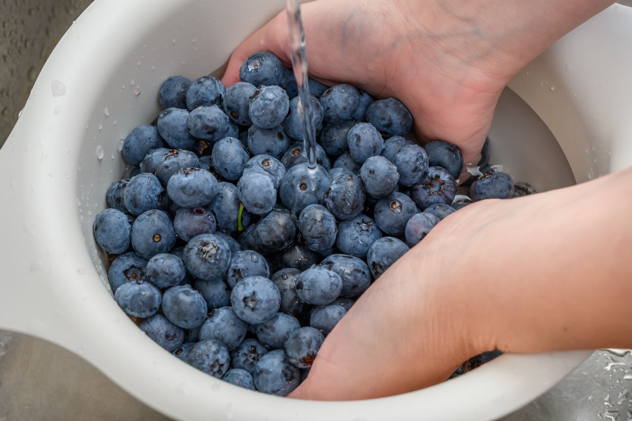 Washing fruits under running water