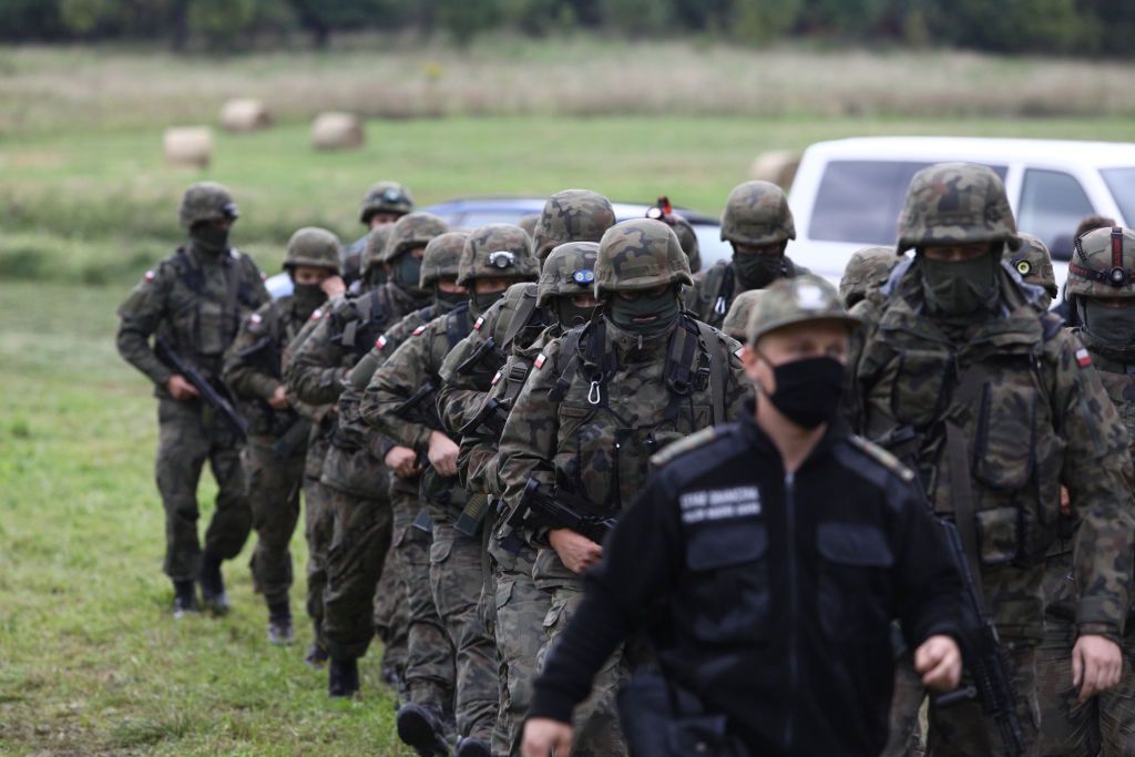 Polish Border Guards In Stand-off With Belarusian Counterparts Over Refugees At Border
Armed members of the Polish Border Guards are seen arriving near the border with Belarus on 20 August, 2021 in Usnarz Gorny, Poland. Around 32 Afghan citizens are being held in place on the border by Polish border guards and Belarusian forces. The refugees are now pawns in a game between Lukashenko's regime who is expelling them forcefully over the border in retlation for EU sanctions and the Polish government which says it will protect Poland from illegal migrants.In the last weeks Belarusian authorities have been pushing an increasing number of refugees, mainly from Iraq over the borders of Poland, Lithuania and Latvia. (Photo by STR/NurPhoto via Getty Images)
NurPhoto
arms, border, border guard, force, fsb, migrant, migration, nationalism, police, refugees, last weeks belarusian authorities, polish border guards, belarusian forces, polish government, armed members, usnarz gorny, 32 afghan citizens, eu sanctions, illegal migrants, increasing number, 20 august, around, place, game, lukashenko, regime, retlation, borders, photo