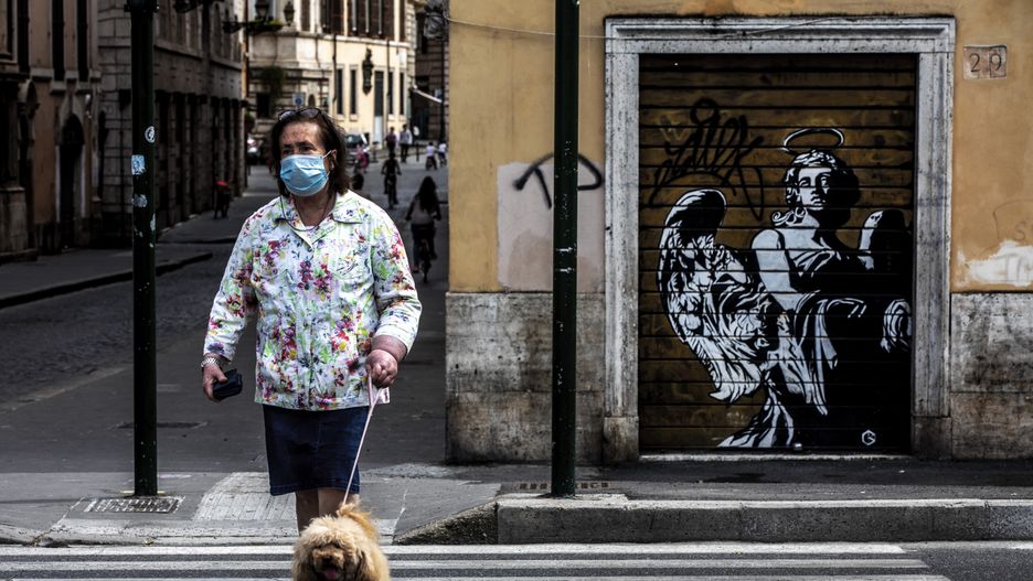 ROME, ITALY - MAY 10: A woman walks with her dog near St. Angelo Bridge on May 10, 2020 in Rome, Italy. Italy has eased its movement restrictions after a two-month lockdown to tackle the coronavirus (COVID-19) pandemic. Around 4.4 million people have returned to work after being confined to their homes since early March. (Photo by Alessandra Benedetti - Corbis/Corbis via Getty Images)