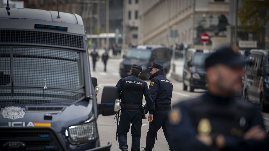 MADRID, SPAIN - NOVEMBER 15: Two agents of the National Police during a demonstration against the investiture of Pedro Sanchez on the day the plenary session in which he will be appointed as new president is held in the Congress of Deputies, on 15 November, 2023 in Madrid, Spain. The Congress of Deputies is armored today with 1,600 agents of the National Police, on the occasion of the investiture session of Pedro Sanchez as president of the Government, which is held at a time of tension due to the concentrations at the headquarters of the PSOE in Ferraz and other points in protest against the amnesty law that benefits those involved in the 'proces'. Last Saturday, November 11, around 500 people camped in front of the Congress, according to the Government Delegation in Madrid, against the act of investiture of Pedro Sanchez. (Photo By Juan Barbosa/Europa Press via Getty Images)