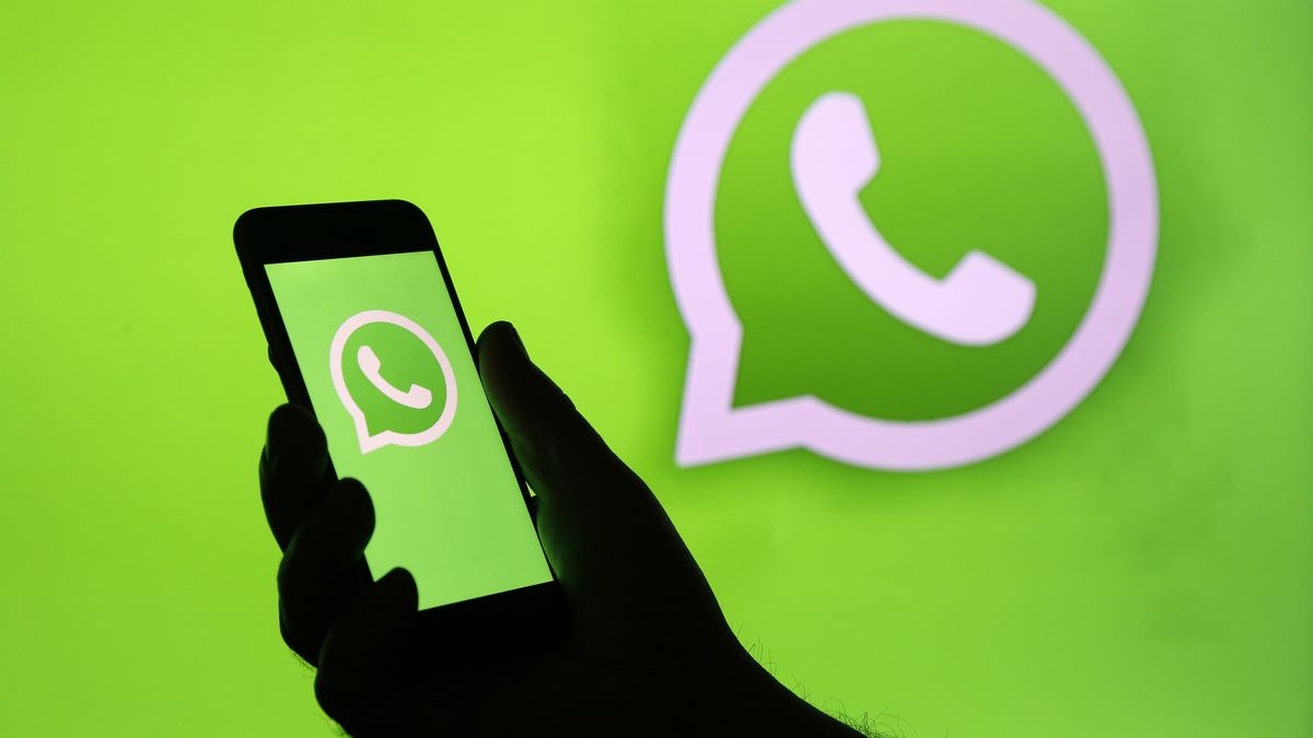 PARIS, FRANCE - DECEMBER 10: In this photo illustration, the WhatsApp logo is displayed on the screen of an iPhone in front of a TV screen displaying the WhatsApp logo on December 10, 2019 in Paris, France. The WhatsApp instant messenger service will stop working on millions of phones in the next couple of months as the company withdraws support for some older mobile platforms. From February 1, 2020, any iPhone running iOS 8 or older will no longer be supported, along with any Android device running version 2.3.7 or older. (Photo by Chesnot/Getty Images)