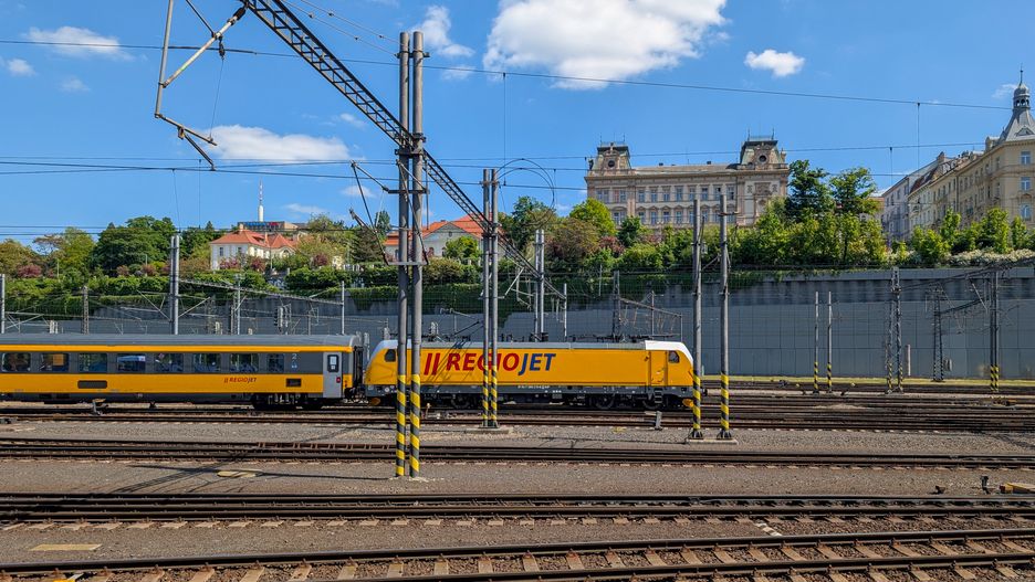 A RegioJet train operated by the Czech rail transport company is at Prague Main Station in Prague, Czech Republic, on May 12, 2025. The yellow train leaves the station. RegioJet operates rail routes around the Czech Republic and Slovakia and operates routes to other European cities, such as Vienna. (Photo by Michael Nguyen/NurPhoto via Getty Images)