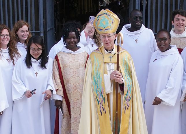 The Archbishop of Canterbury Justin Welby poses for a photograph with members of the Community of Saint Anselm as he leaves the Easter Sung Eucharist at Canterbury Cathedral in Kent. Picture date: Sunday April 17, 2022. (Photo by Gareth Fuller/PA Images via Getty Images)