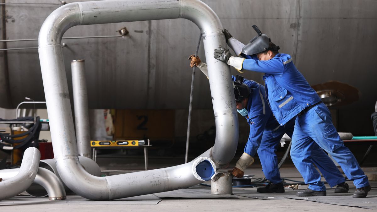 HUZHOU, CHINA - DECEMBER 16: Workers manufacture core equipment for photovoltaic projects at Zhejiang Dachuan Air Separation Plant Co., Ltd. on December 16, 2025 in Huzhou, Zhejiang Province of China. The core equipment for photovoltaic projects will be exported to Southeast Asian countries. (Photo by Ni Lifang/VCG via Getty Images)