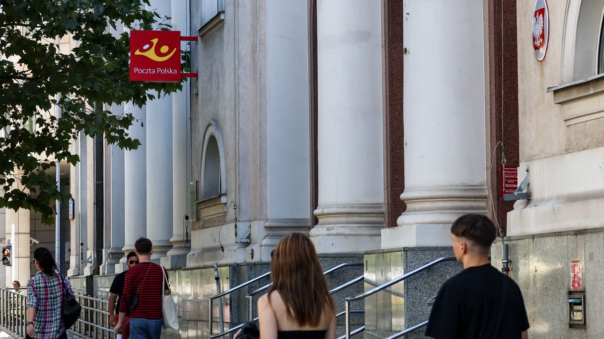 People walk in front of a logo of Polish Post on a main office of the company in central Warsaw, the capital of Poland on August 13, 2024. Polish Post has appointed new vice directors this week and is expected to start restructuring the company after a long period of financial inefficiency. (Photo by Dominika Zarzycka/NurPhoto via Getty Images)
