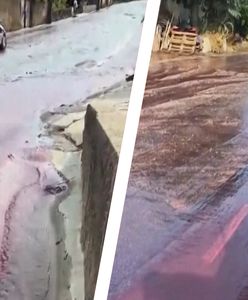 Rzeka czerwonego wina na ulicy w Portugalii. Świadek chwycił za telefon