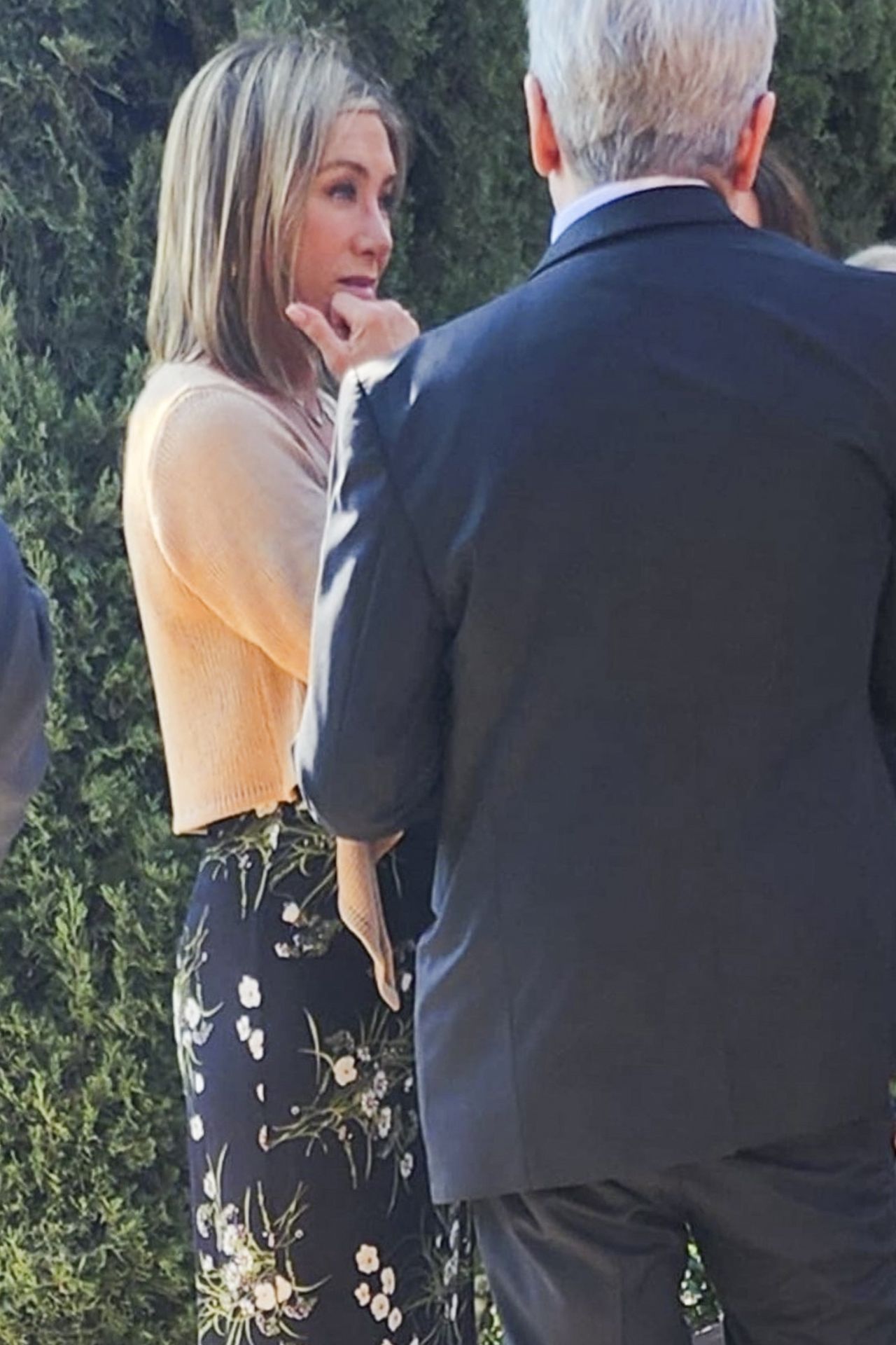 Jennifer Aniston in a low-cut dress rushes to the funeral.