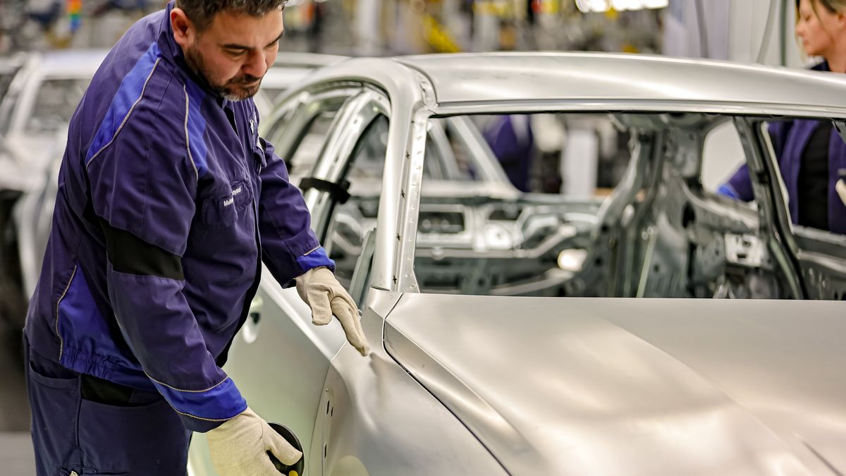 MUNICH, GERMANY - DECEMBER 05: A member of BMW's manufacturing staff inspects a vehicle's finish as he works at the body shop finish during German Chancellor Olaf Scholz visits the BMW Group car factory on December 05, 2023 in Munich, Germany. His visit is taking place as Scholz's government wrestles with a federal budget crisis stemming from a recent Federal Constitutional Court ruling. (Photo by Leonhard Simon/Getty Images)