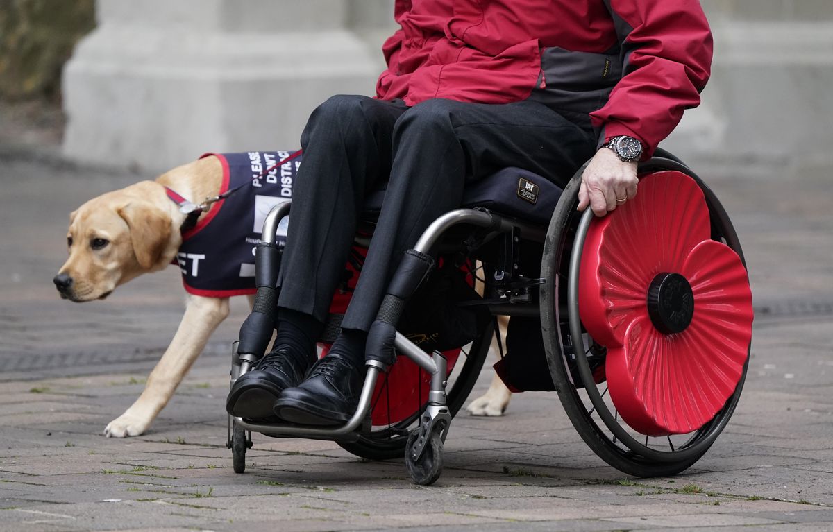 A veteran with a poppy on the wheels of their wheelchair makes their way into the Guildhall Square, in Portsmouth, before a Remembrance Service. Picture date: Sunday November 14, 2021. (Photo by Andrew Matthews/PA Images via Getty Images)