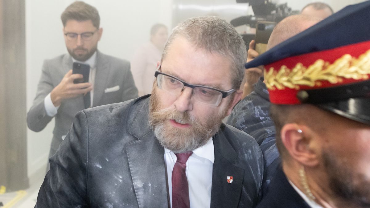 Grzegorz Braun, a far-right Polish lawmaker, is using a fire extinguisher on Hanukkah candles in parliament in Warsaw, Poland, on December 12, 2023. (Photo by Foto Olimpik/NurPhoto via Getty Images)