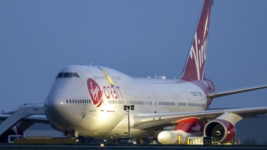 NEWQUAY, ENGLAND - JANUARY 09: A general view of Cosmic Girl, a Boeing 747-400 aircraft carrying the LauncherOne rocket under its left wing, as final preparations are made at Cornwall Airport Newquay on January 9, 2023 in Newquay, United Kingdom. Virgin Orbit launches its LauncherOne rocket from the spaceport in Cornwall, marking the first ever orbital launch from the UK. The mission has been named Start Me Up after the Rolling Stones hit. (Photo by Matthew Horwood/Getty Images)