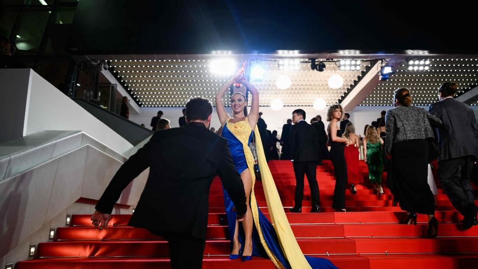 Temporary
A protester, wearing a dress in the colours of the Ukrainian flag, covers herself in fake blood on the stairs on the Festival Palace ahead of the screening of the film "Acide" during the 76th edition of the Cannes Film Festival in Cannes, southern France, on May 21, 2023. (Photo by CHRISTOPHE SIMON / AFP)
CHRISTOPHE SIMON