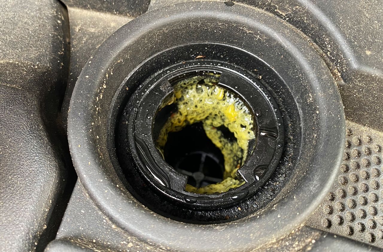 Yellow substance under the oil cap may be considered a symptom of a head gasket failure. Often unjustly.