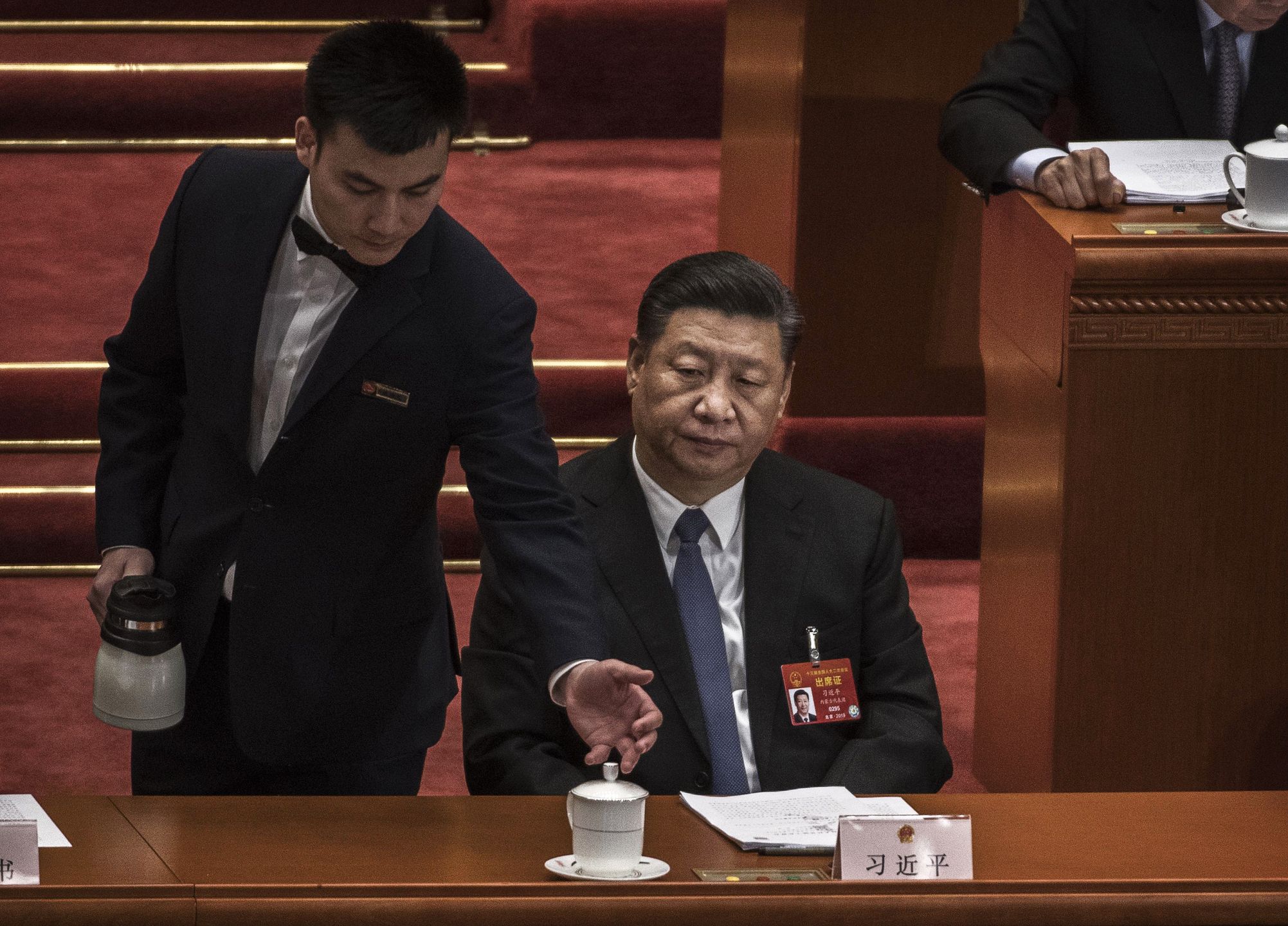 China's National People's Congress (NPC) - Third Plenary MeetingBEIJING, CHINA - MARCH 12: Chinese President Xi Jinping is served tea during the third plenary session of the National People's Congress at The Great Hall Of The People on March 12, 2019 in Beijing, China.The annual Two Sessions gathering of Communist Party officials and delegates lays out a road map for the governments year ahead, including economic growth targets, diplomacy and military spending.  Chinas premier Li Keqiang warned of a more complicated environment with a slowing economy and talks with the U.S. to avert an all-out trade war after the threat of billions of dollars in reciprocal tariffs. The meetings last until March 15, 2019.  (Photo by Kevin Frayer/Getty Images)Kevin Frayer