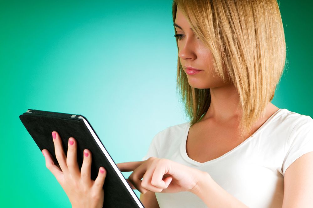 Girl working with the portable tablet computer