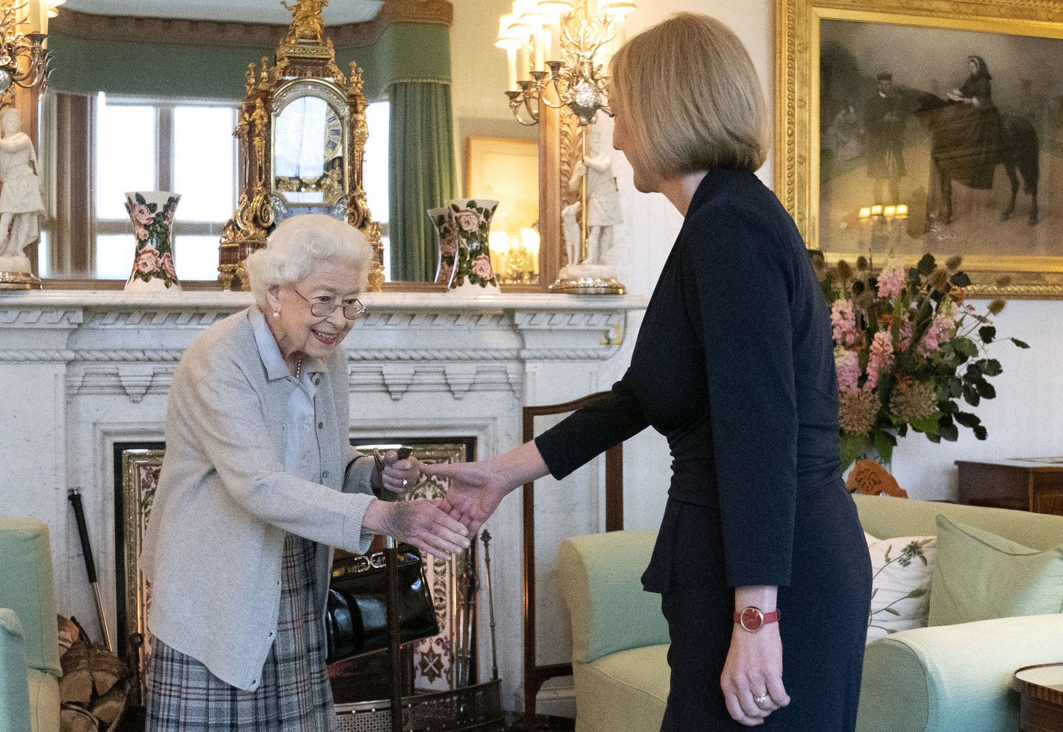 Queen Elizabeth Receives Outgoing And Incoming PMs At BalmoralABERDEEN, SCOTLAND - SEPTEMBER 06: Queen Elizabeth greets newly elected leader of the Conservative party Liz Truss as she arrives at Balmoral Castle for an audience where she will be invited to become Prime Minister and form a new government on September 6, 2022 in Aberdeen, Scotland. The Queen broke with the tradition of meeting the new prime minister and Buckingham Palace, after needing to remain at Balmoral Castle due to mobility issues. (Photo by Jane Barlow - WPA Pool/Getty Images)WPA Pool