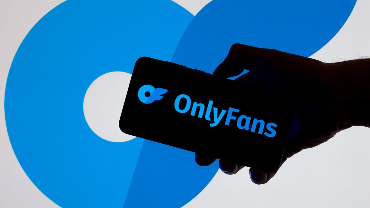The OnlyFans logo is displayed on a mobile phone with the company branding icon visible in the background in this photo illustration in Brussels, Belgium, on November 24, 2025. (Photo by Jonathan Raa/NurPhoto via Getty Images)