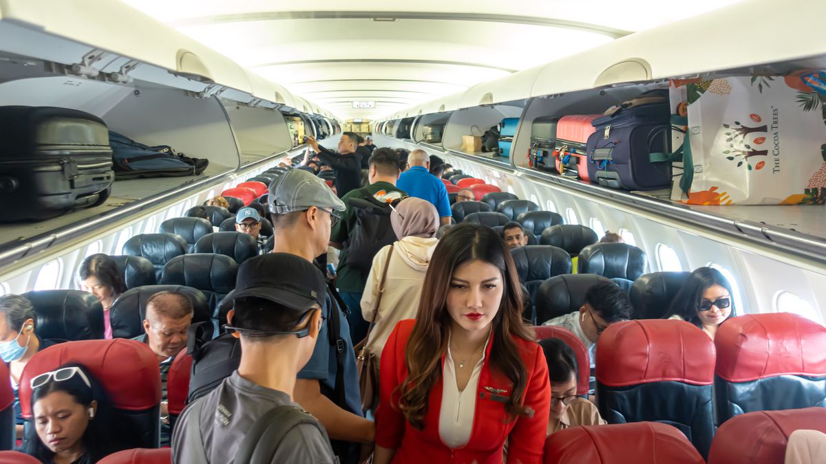 A flight attendant uniform assisting passengers in Airbus A320 operated by AirAsia Indonesia, crowded cabin, standing passengers, luggage, board, boarding
A flight attendant uniform assisting passengers in Airbus A320 operated by AirAsia Indonesia, crowded cabin, standing passengers, luggage, board, boarding. (Photo by: ruelleruelle/UCG/Universal Images Group via Getty Images)
UCG
crowd, worker, crowded cabin, seats, stewardess, airliner, plane, flight attendants, interiors, jetliner, stewardesses, asian, board, jetliners, interior, airliners, culture cultural, female, airbus a 320, airplanes, planes, jets, overhead, jet, aircrafts, aviation, workplace, work, type, job, aircraft