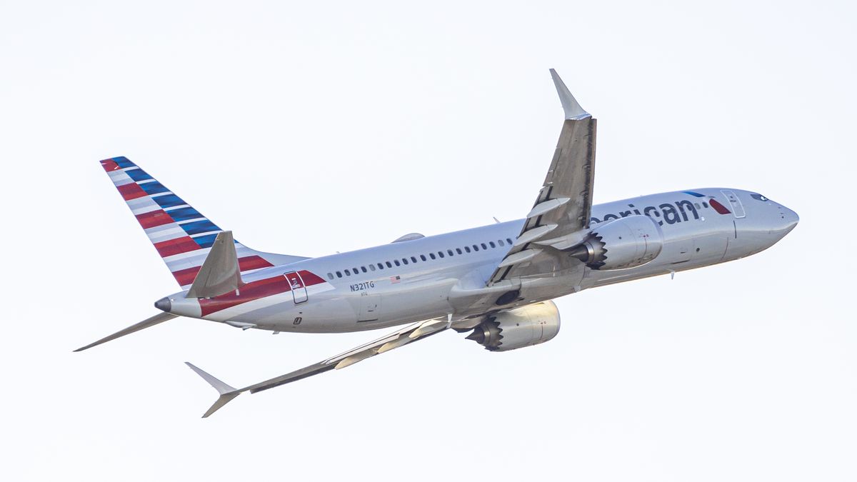 American Airlines Boeing 737 MAX 8 passenger aircraft spotted during takeoff and flying in front of the airport terminal, air traffic control tower and planes from Ronald Reagan Washington National Airport DCA, the closest airport to US capital Washington, D.C,. The AA narrow body airplane has the registration tail number N321TG and is powered by 2x CFMI LEAP 1B jet engines. American Airlines AAL is a major airline in the United States with headquarters and main hub in Fort Worth, Texas, USA. American Airlines is the largest airline in the world with a fleet of 970 planes, operating regional subsidiaries with the brand name American Eagle, member of Oneworld aviation alliance group. Crystal City, Virginia, United States on November 8, 2024 (Photo by Nicolas Economou/NurPhoto via Getty Images)
