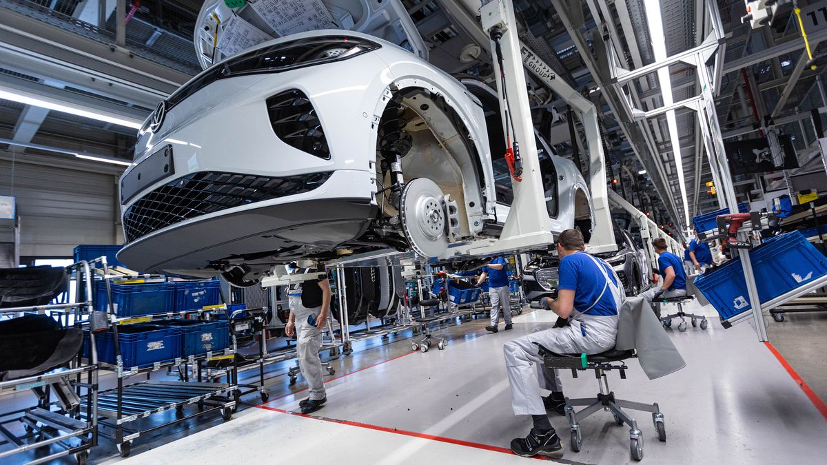Employees work on the bodies of Volkswagen AG (VW) ID.5 electric sports utility vehicles (eSUV) on the assembly line at the automaker's electric automobile plant in Zwickau, Germany, on Tuesday, April 26, 2022. The Zwickau assembly lines are the centerpiece of a plan by VW, the world's biggest automaker, to manufacture as many as 330,000 cars annually. Photographer: Krisztian Bocsi/Bloomberg via Getty Images