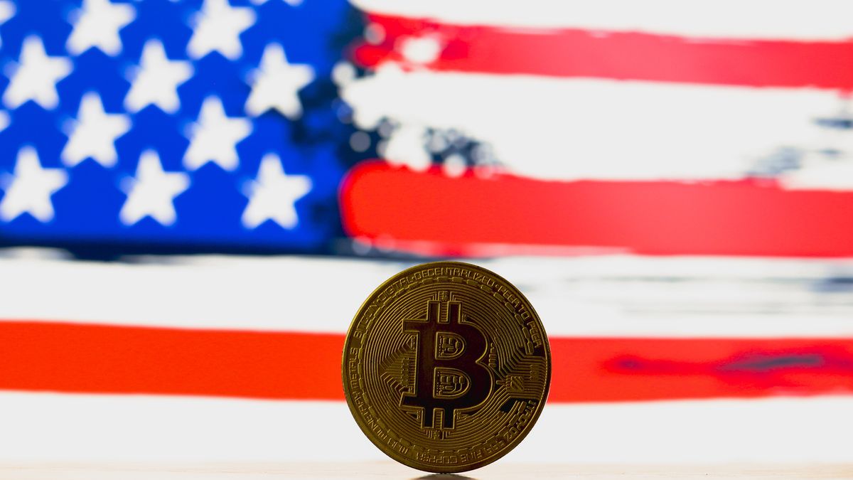 PARAGUAY - 2024/07/03: In this photo illustration, a Bitcoin is seen on the table and the United States flag in the background. (Photo Illustration by Jaque Silva/SOPA Images/LightRocket via Getty Images)