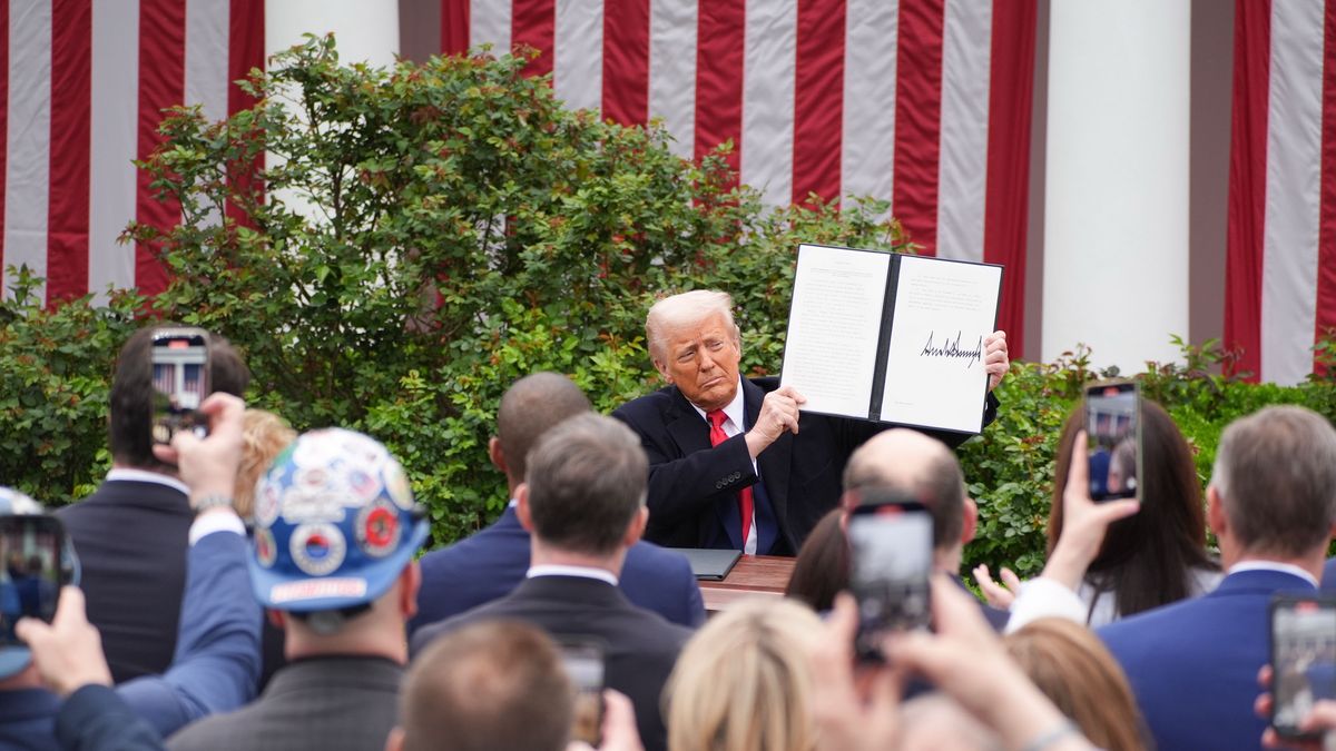 Washington, DC - April 2: President Donald Trump signs an executive order after announcing a plan for tariffs on imported goods during an event Wednesday, April 2, 2025, in the Rose Garden at the White House. At right is Commerce Secretary Howard Lutnick. 

(Photo by Demetrius Freeman/The Washington Post via Getty Images)