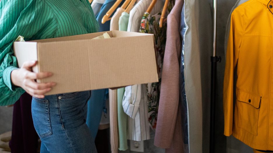 Young woman preparing clothes for packing and delivering for her online clothing store