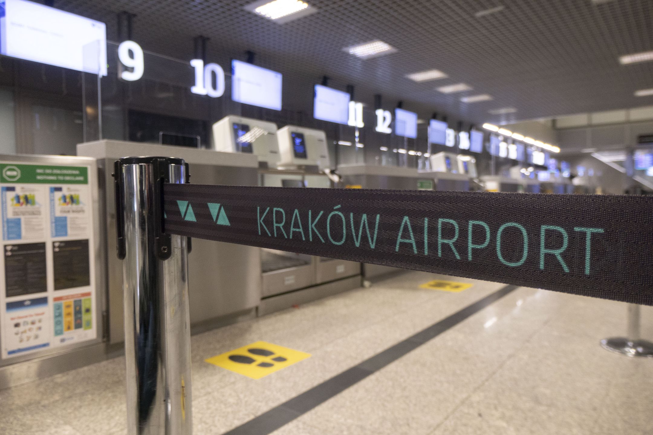 KRAKOW AIRPORT logo inscription on a belt strap passenger divider. Kraków John Paul II International Airport KRK known as Krakow Balice airport. Check-in desks, arrival and departure hall and the gates area of the Polish airport terminal. It is the second largest airport in terms of passenger traffic in Poland. The aviation industry and passenger traffic volume are phasing a difficult period with the Covid-19 coronavirus pandemic having a negative impact on the travel business industry with fears of a deteriorating situation due to the new variant mutation like Omicron at the fifth wave. Krakow, Poland on March 18, 2022 (Photo by Nicolas Economou/NurPhoto via Getty Images)