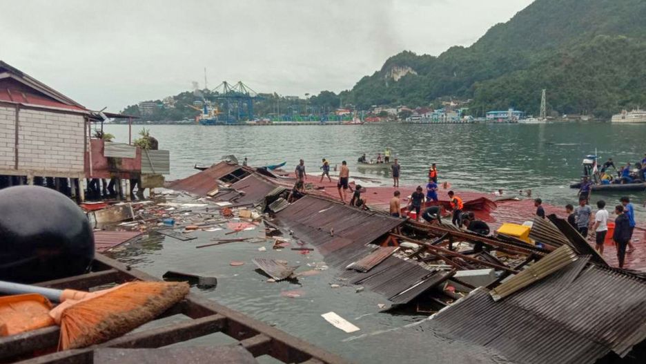 Temporary
People stand on the roofing of collapsed shops in the port after a 5.1-magnitude earthquake in Jayapura, Indonesia's eastern province of Papua on February 9, 2023. (Photo by FAISAL NARWAWAN / AFP)
FAISAL NARWAWAN