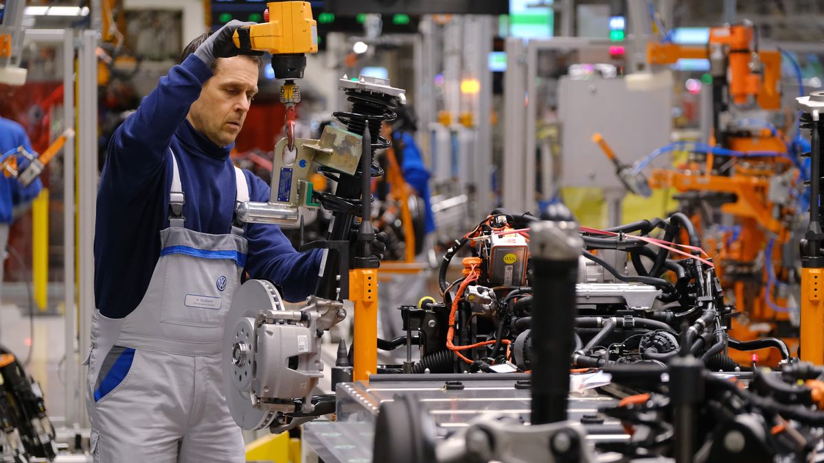 ZWICKAU, GERMANY - FEBRUARY 25: Workers assemble the lower body that includes the battery and motor on an ID.3 electric car on the assembly line at the Volkswagen factory on February 25, 2020 in Zwickau, Germany. Volkswagen is gradually revving up ID.3 production at the Zwickau plant from a current 110 per day to an eventual 1,500. The Zwickau plant is the first of its many factories that Volkswagen is retooling from producing combustion engine cars to only producing electric cars. Sales of the ID.3 will begin this summer.    (Photo by Sean Gallup/Getty Images)