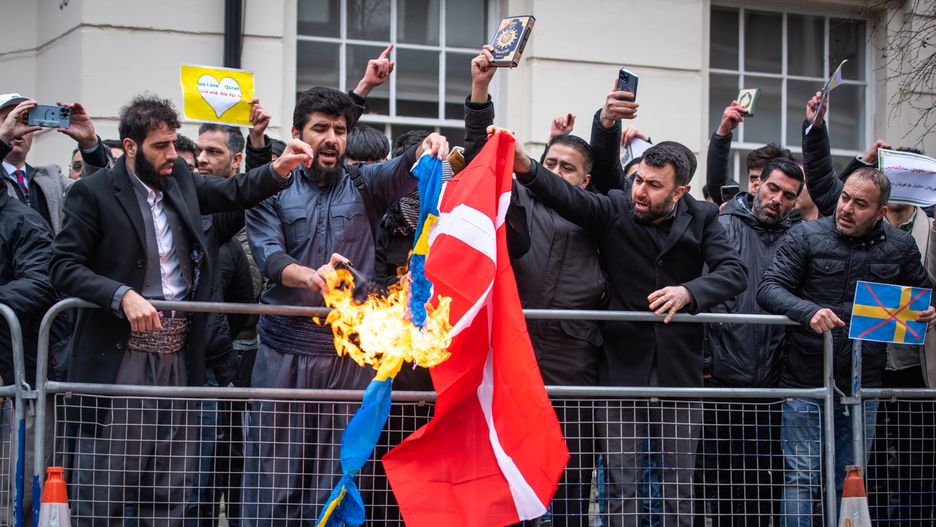 LONDON, UNITED KINGDOM - 2023/01/28: Protestors burn the Swedish and Danish flags during the demonstration against the Quran Burning In Sweden. A high representative of the United Nations Alliance of Civilizations has condemned the burning of the Muslim holy book by a Swedish-Danish far-right politician as a vile act. Rasmus Paludan, leader of the Danish far-right political party Hard Line, carried out the stunt outside the Turkish embassy in Sweden under the protection of local police on Friday 27 January 2023. (Photo by Loredana Sangiuliano/SOPA Images/LightRocket via Getty Images)
