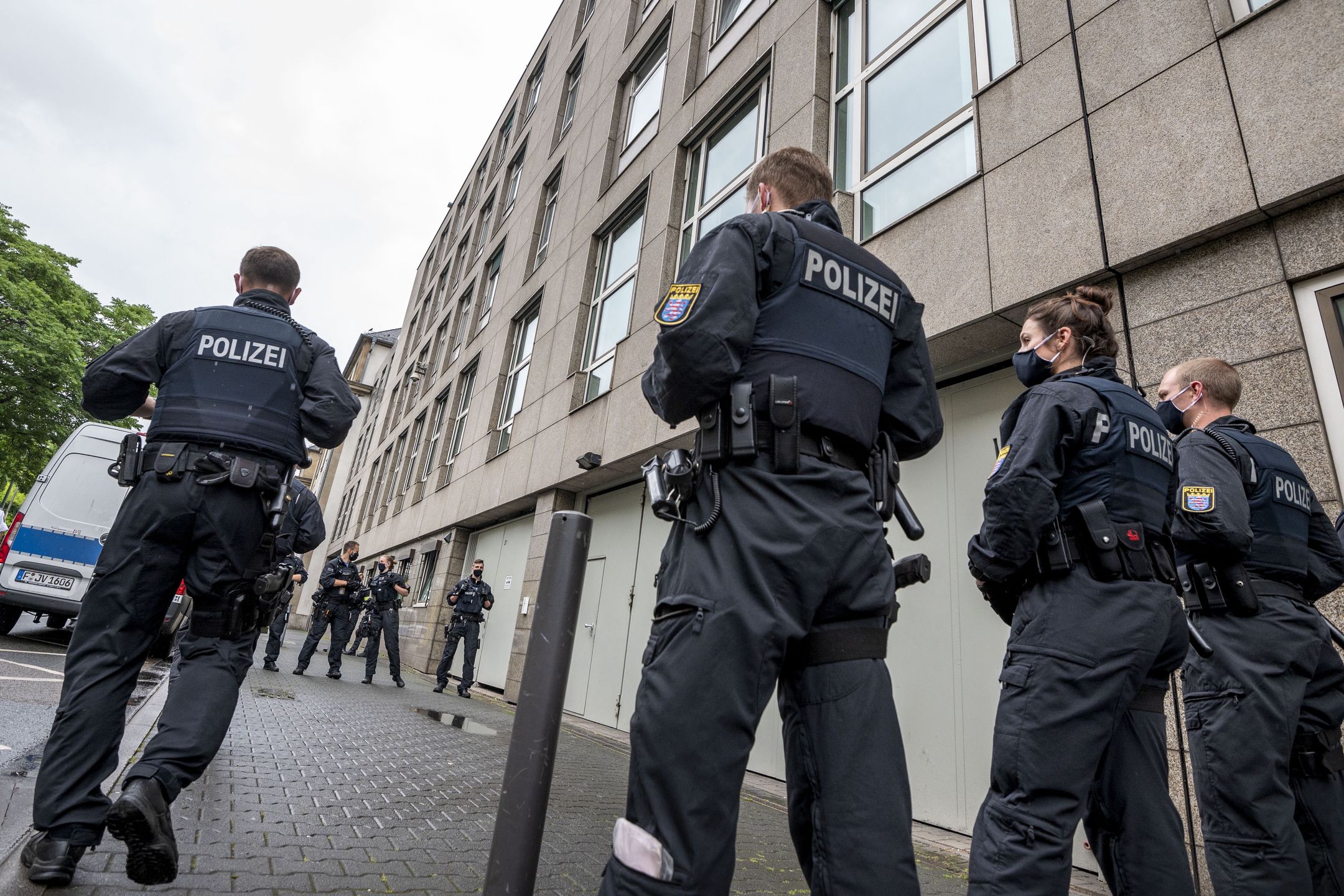 FRANKFURT AM MAIN, GERMANY - JUNE 16: Police officers wait for the departure of Stefan Ernst, who is accused of murdering politician Walter Luebcke, and Walter H. after the first day of the trial at the Oberlandgericht Frankfurt courthouse on June 16, 2020 in Frankfurt, Germany. Ernst, who has a history of right-wing extremism, is accused of shooting Luebcke, a politician of the German Christian Democrats (CDU) in the state of Hesse who had been outspoken in his support of refugees, in the head while Luebcke sat on the terrace of his home on June 2, 2019. Co-defendant Markus H. is accused of aiding and abetting the crime.  (Photo by Thomas Lohnes/Getty Images)