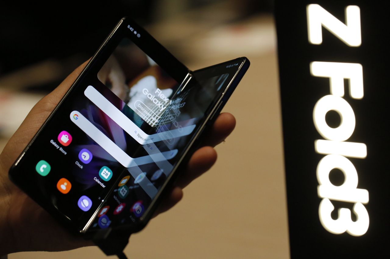 An attendee handles a Galaxy Z Fold3 smartphone on the Samsung Electronics Co. stand on the opening day of the MWC Barcelona at the Fira de Barcelona venue in Barcelona, Spain, on Monday, Feb. 28, 2022. Over 1,800 exhibitors and attendees from 183 countries will attend the annual event, which runs from Feb. 28 to March 3. Photographer: Angel Garcia/Bloomberg via Getty Images