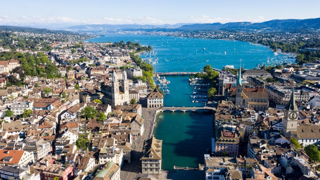 Zurich During The Coronavirus Pandemic
ZURICH, SWITZERLAND - JULY 12: An aerial drone view of the city centre of Zurich, Limmat River, Lake Zurich, and the Grossmuenster Church stand during the coronavirus pandemic on July 12, 2020 in Zurich, Switzerland. Switzerland has largely lifted most of its coronavirus lockdown measures and has so far registered approximately 33,000 infections.  (Photo by Christian Ender/Getty Images).
Christian Ender