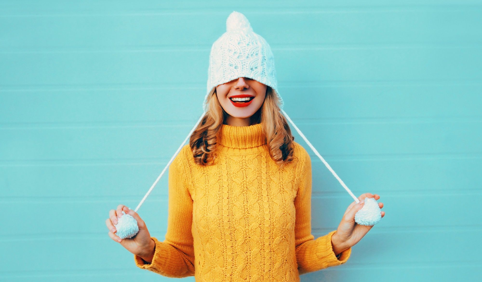 Winter portrait happy smiling young woman having fun pulls a hat over her eyes wearing yellow knitted sweater and white hat with pom pom on blue wall backgroundWinter portrait happy smiling young woman having fun pulls a hat over her eyes wearing yellow knitted sweater and white hat with pom pom on blue wall backgroundfashion, woman, winter, happy, fun, smiling, joyful, person, cheerful, christmas, girl, sweater, wish, young, playful, teenager, mood, hat, knitted, portrait, trendy, carefree, laughing, surprised, xmas, dream, emotions, beautiful, happiness, funny, female, model, cool, vacation, enjoy, yellow, season, color, attractive, vitality, expression, delighted, pretty, clothes, cute, knitwear, background, lifestyle, blue, white, fashion, woman, winter, happy, fun, smiling, joyful, person, cheerful, christmas, girl, sweater, wish, young, playful, teenager, mood, hat, knitted, portrait, trendy, carefree, laughing, surprised, xmas, dream, emotions, beautiful, happiness, funny, female, model, cool, vacation, enjoy, yellow, season, color, attractive, vitality, expression, delighted, pretty, clothes, cute, knitwear, background, lifestyle, blue, white