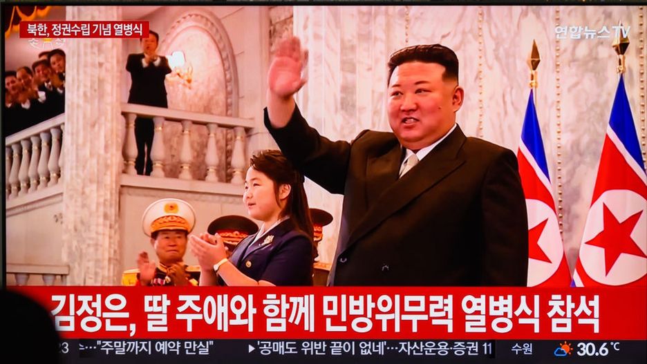 A TV screen shows the North Korean 