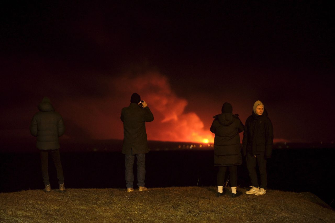 Tourists observe the volcano