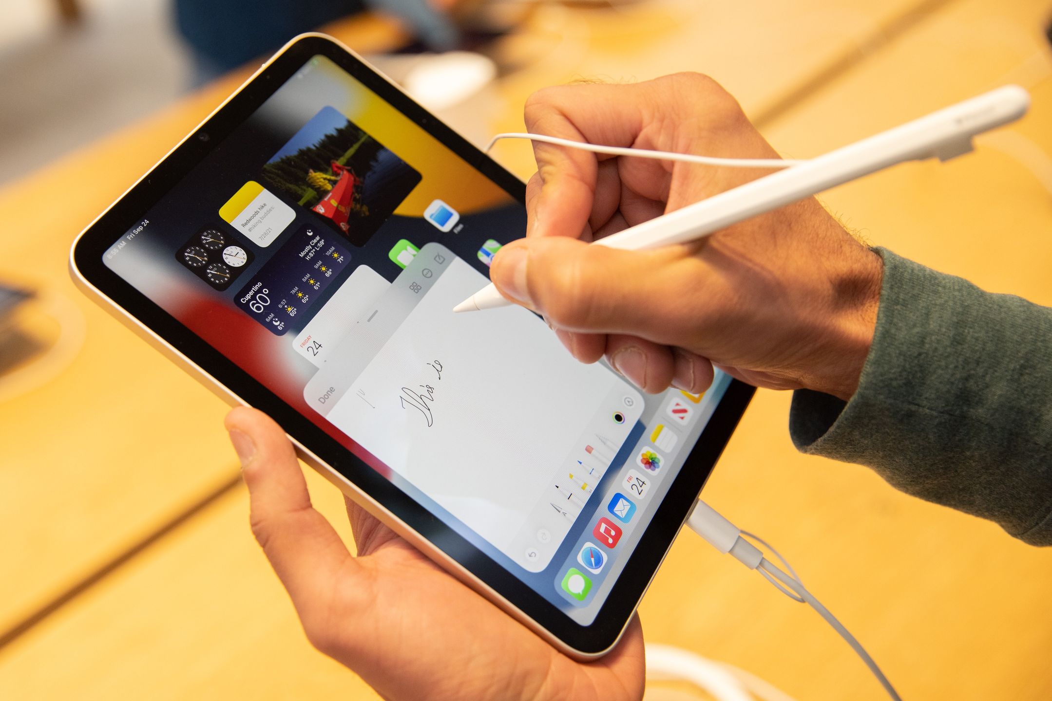 A customer uses an Apple iPad Mini tablet for sale at a store in New York, U.S., on Friday, Sept. 24, 2021. Apple Inc. is releasing its iPhone 13 lineup, testing whether new camera technology and aggressive carrier deals will get shoppers to snap up a modest update of last years model. Photographer: Jeenah Moon/Bloomberg via Getty Images