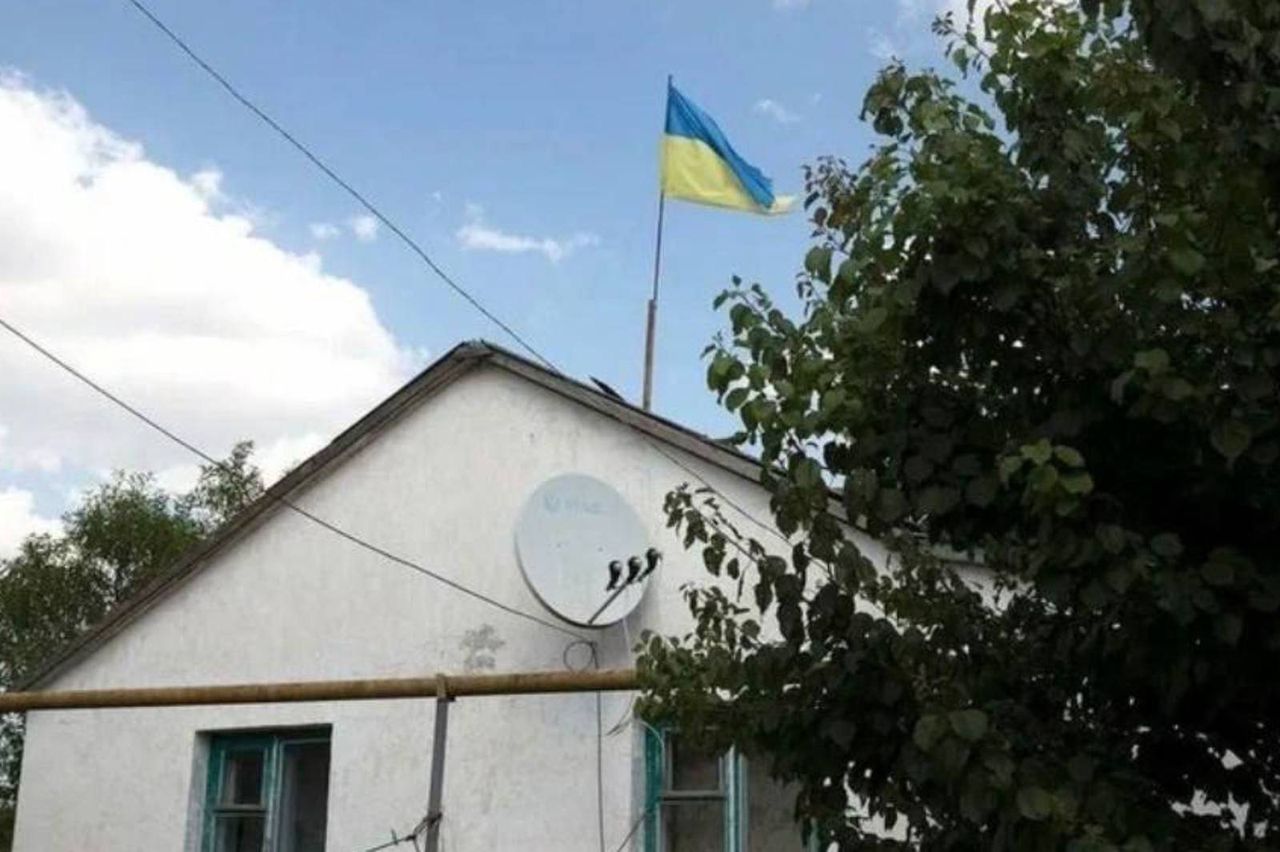 Russians are hanging Ukrainian flags on their homes.