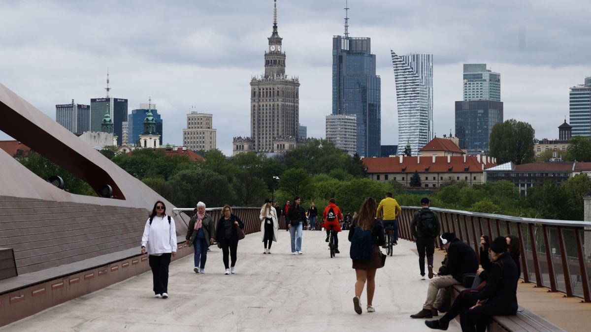 People walk the footbridge in Warsaw, Poland on April 12, 2024. (Photo by Jakub Porzycki/NurPhoto via Getty Images)