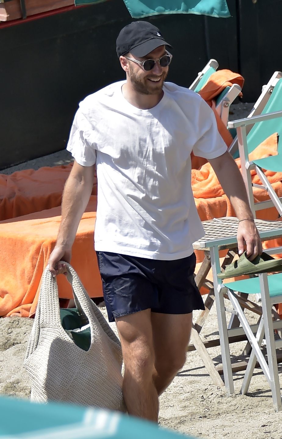 *EXCLUSIVE* Danish footballer Christian Eriksen with his wife Sabrina Kvist Jensen and their children on vacation in Portofinoportofino, ITALY  - *EXCLUSIVE*  - Danish footballer Christian Eriksen who suffered a cardiac arrest while playing for Denmark at Euro 2020 seems to have made a full recovery as he is seen with his wife Sabrina Kvist Jensen and their children enjoying a beach day in Portofino.BACKGRID UK 15 AUGUST 2021,Image: 627239989, License: Rights-managed, Restrictions: RIGHTS: WORLDWIDE EXCEPT IN ITALY, Model Release: no, Credit line: Cobra Team / BACKGRID / Backgrid UK / ForumCobra Team / BACKGRID / Backgrid UK / ForumChristian Eriksen, Black Cap, Nike, Brand, Facial Hair, Beard, Black Sunglasses, White T-Shirt, Black Shorts, Holding, Football Player, Footballer, Holiday, Vacation, Enjoy, Enjoying