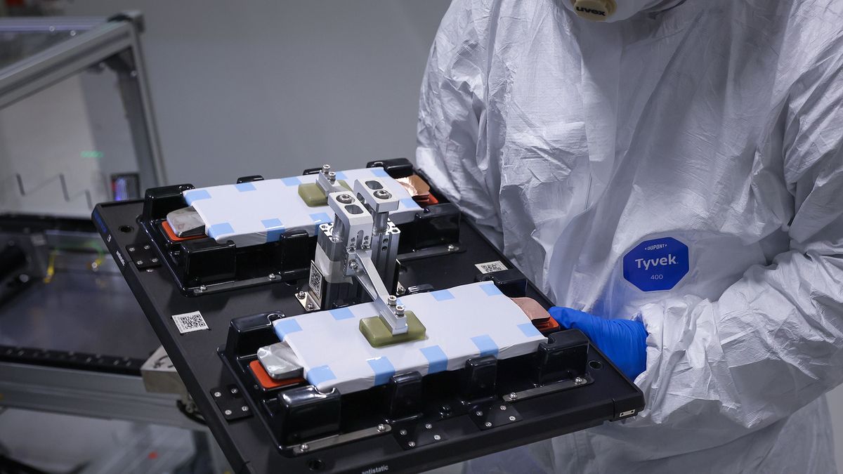 SALZGITTER, GERMANY - DECEMBER 12:  In this image released on December 17, an employee moves stacks of battery cells in a clean room in the stacking production area at the new PowerCo Gigafactory on 12 December 2025 in Salzgitter, Germany. PowerCo is Volkswagen's electric car battery division. The Gigafactory in Salzgitter is expected to be fully operational in early 2026 and will produce electric car batteries for smaller vehicles in the Volkswagen and Skoda electric car model ranges. (Photo: Ronny Hartmann/Getty Images)