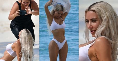 Kim Kardashian z poświęceniem wije się na plaży, prezentując rozmaite pozy... (ZDJĘCIA)