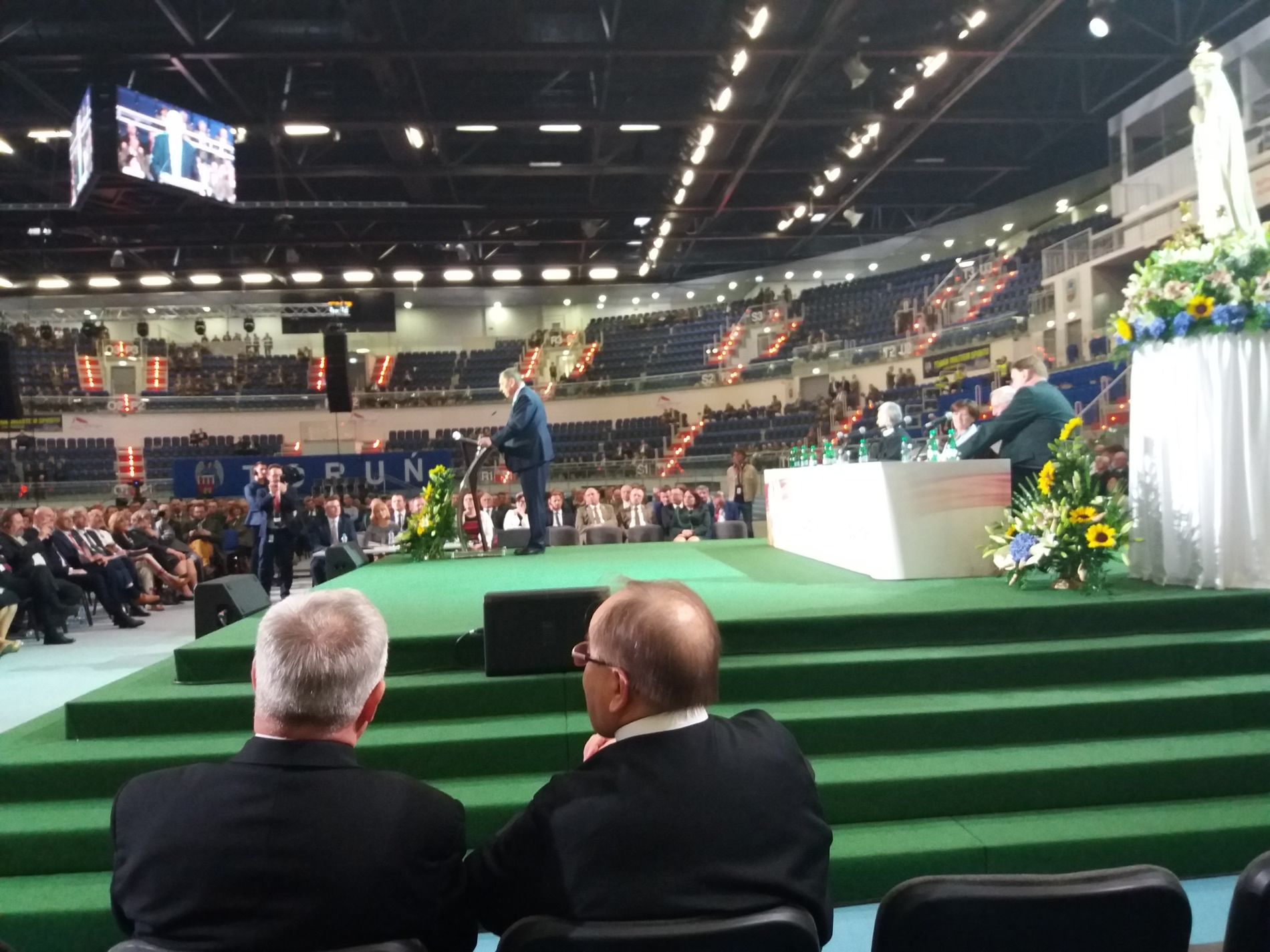 O. Tadeusz Rydzyk na konferencji w Toruniu. W tle przemawia Jan Szyszko