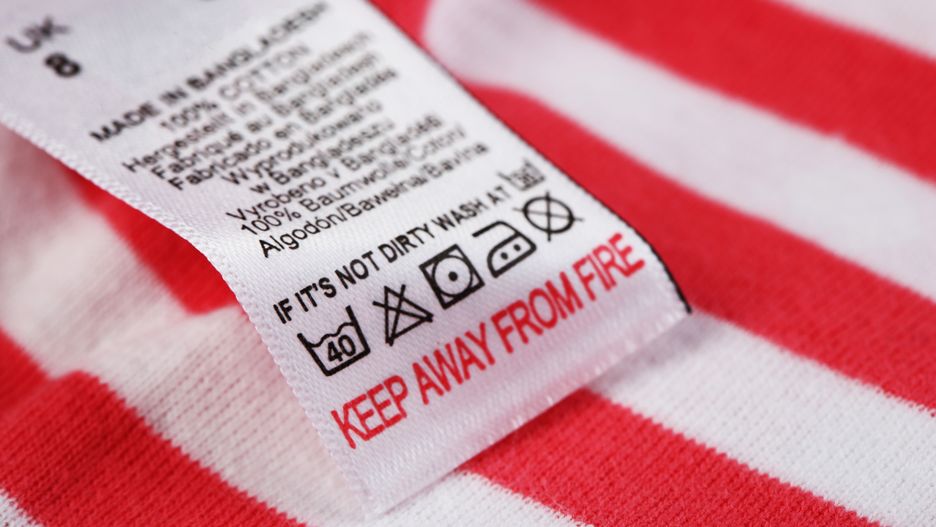Label with laundry care symbols close-up on clothing