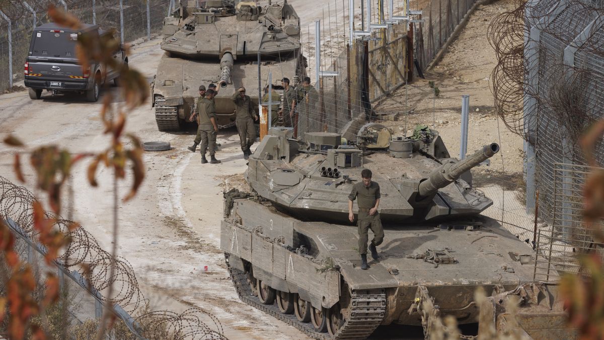 Two Israel Defense Forces tanks between border fences along the buffer zone seen from the Golan Heights in Majdal Shams, Israel, on Wednesday, Dec. 11, 2024. The United Arab Emirates has strongly condemned the Israeli forces' seizure of the buffer zone in the Golan Heights, according to a statement by the Ministry of Foreign Affairs. Photographer: Kobi Wolf/Bloomberg via Getty Images